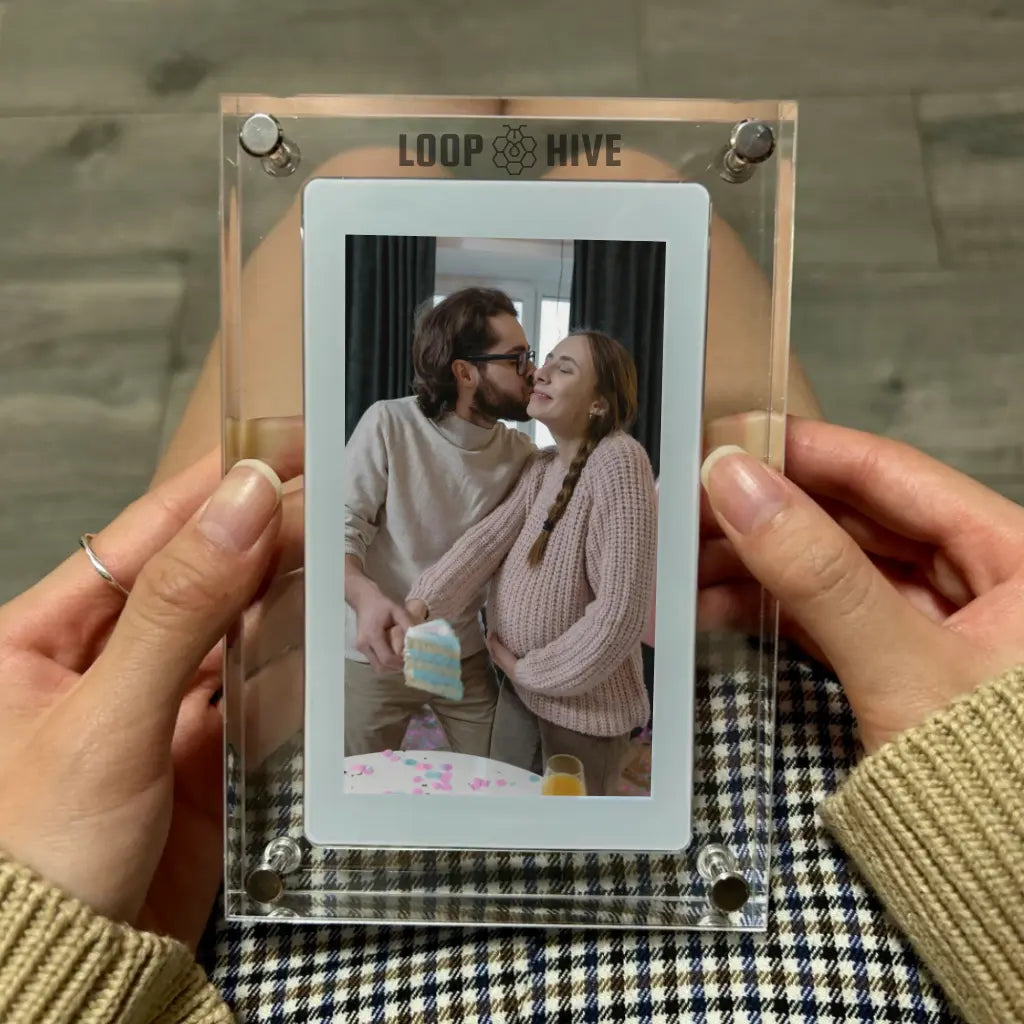 a photo of pregnant couple cutting a gender reveal cake displayed on loop frame.